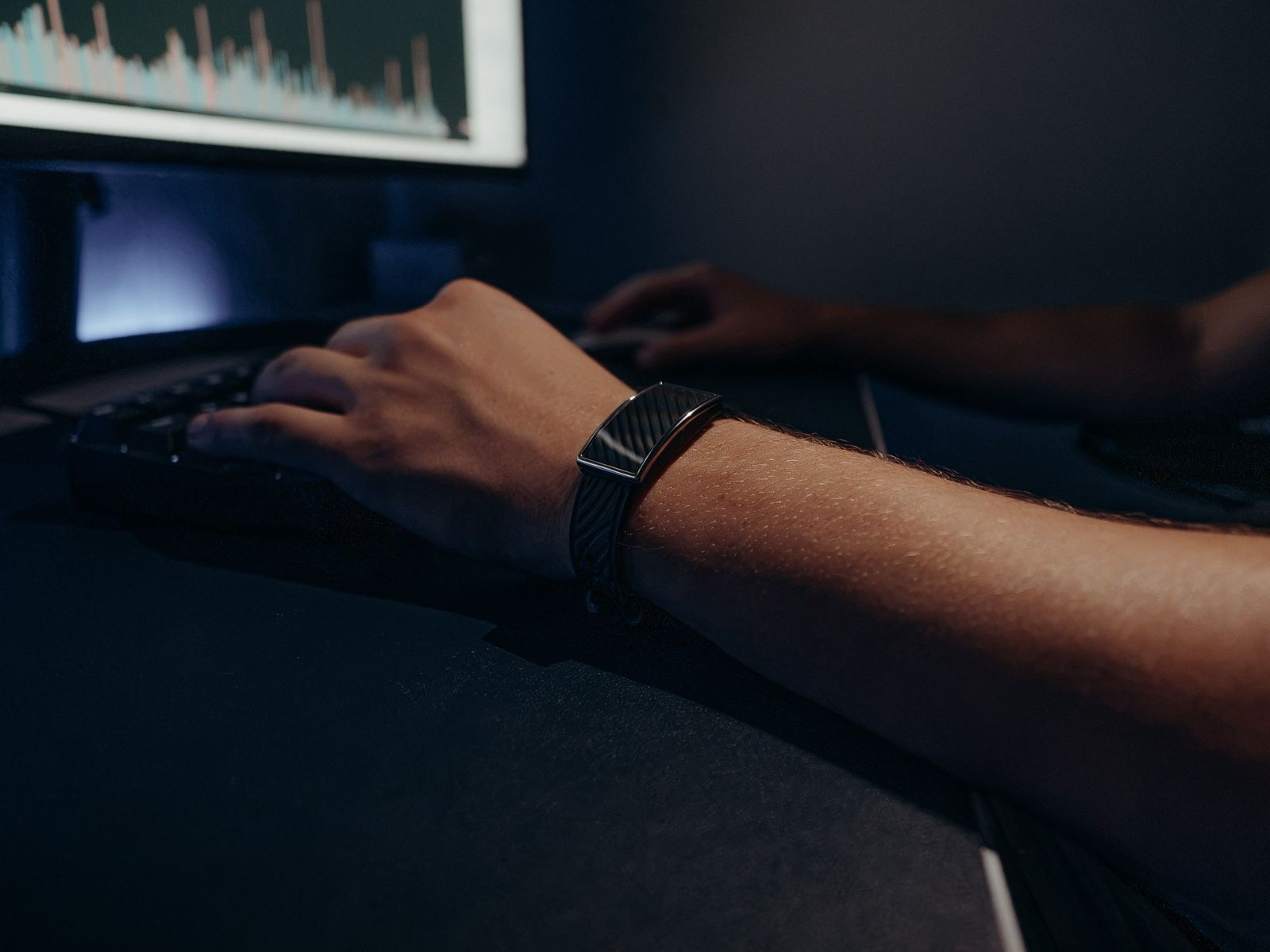 Someone monitoring data on a dimly lit screen, the account-watching work a migrated campaign needs going forward.