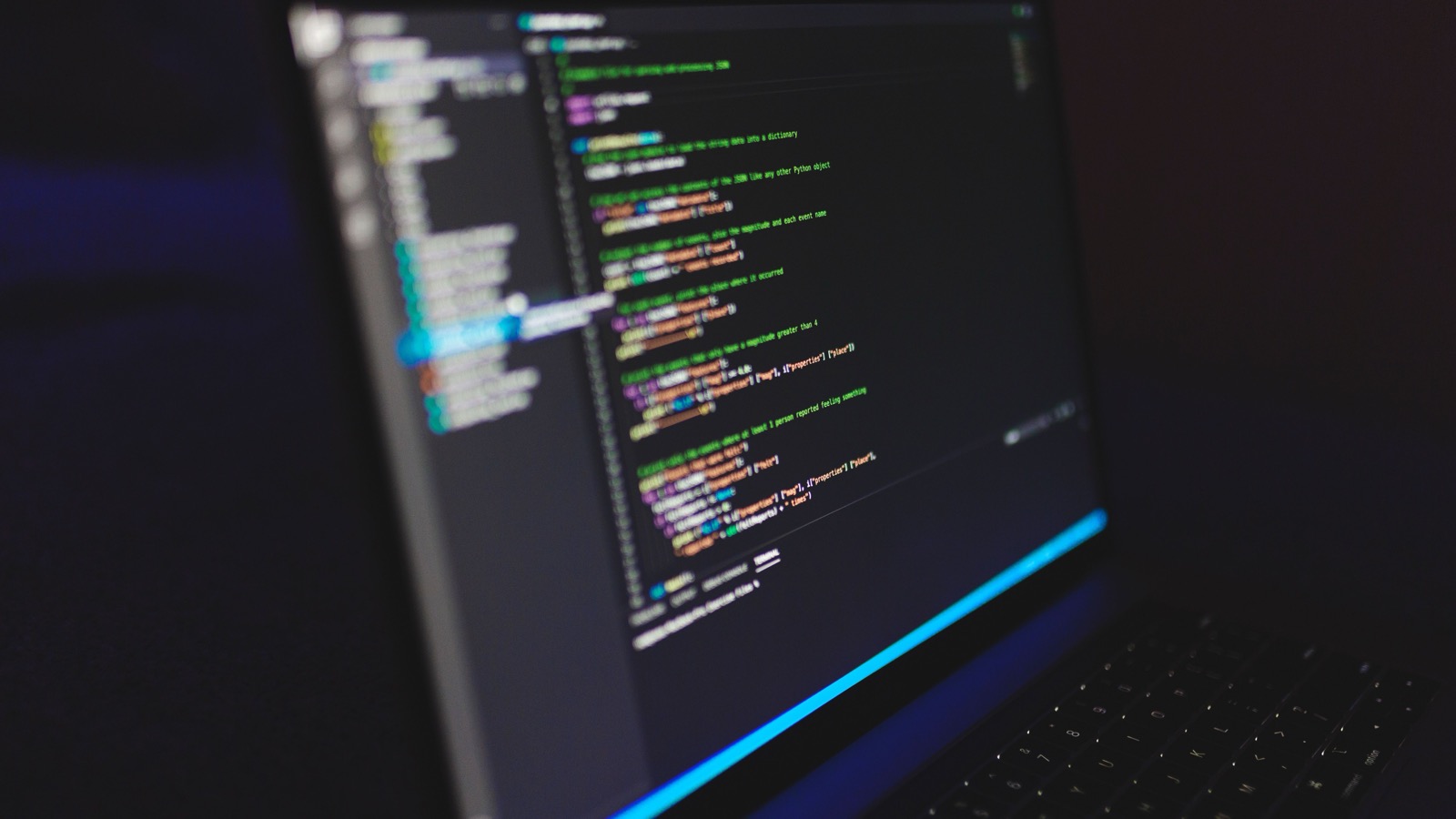 Close-up of a laptop screen lit with code in a dark room, the script work behind an AI Max migration.